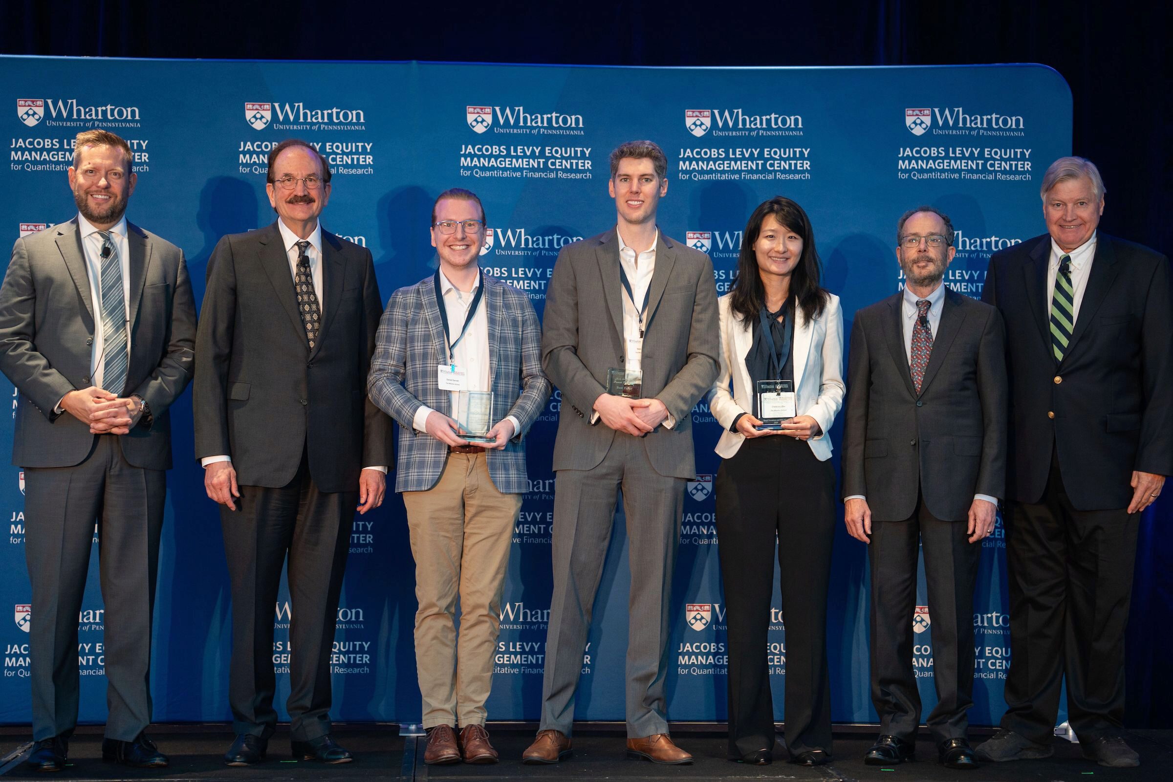 Jacobs Levy Paper Prize recipients stand with their awards along with Christopher Geczy, Bruce Jacobs, Ken Levy, and Craig MacKinlay