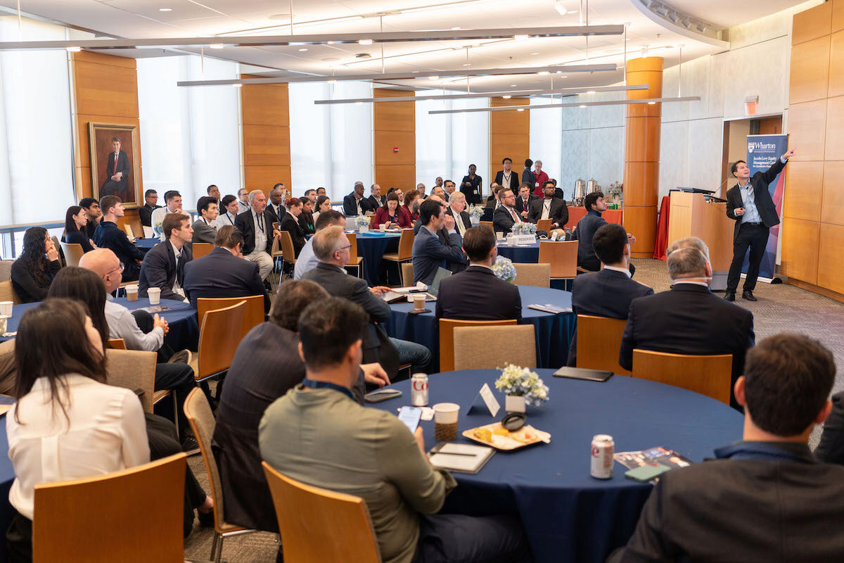 Alejandro Lopez-Lira presents in front of a full crowd at the 2024 Frontiers in Quantitative Finance Conference