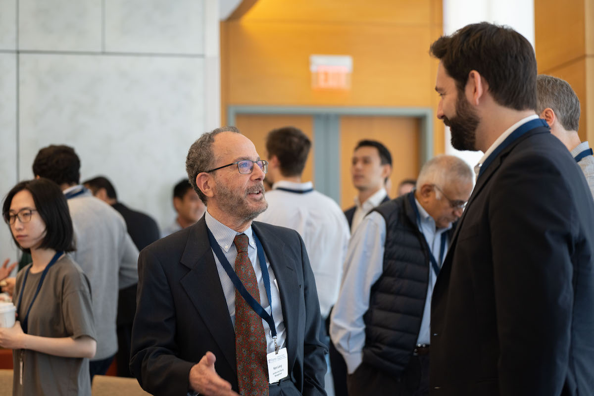 Ken Levy speaks with a Frontiers in Quantitative Finance Conference participant