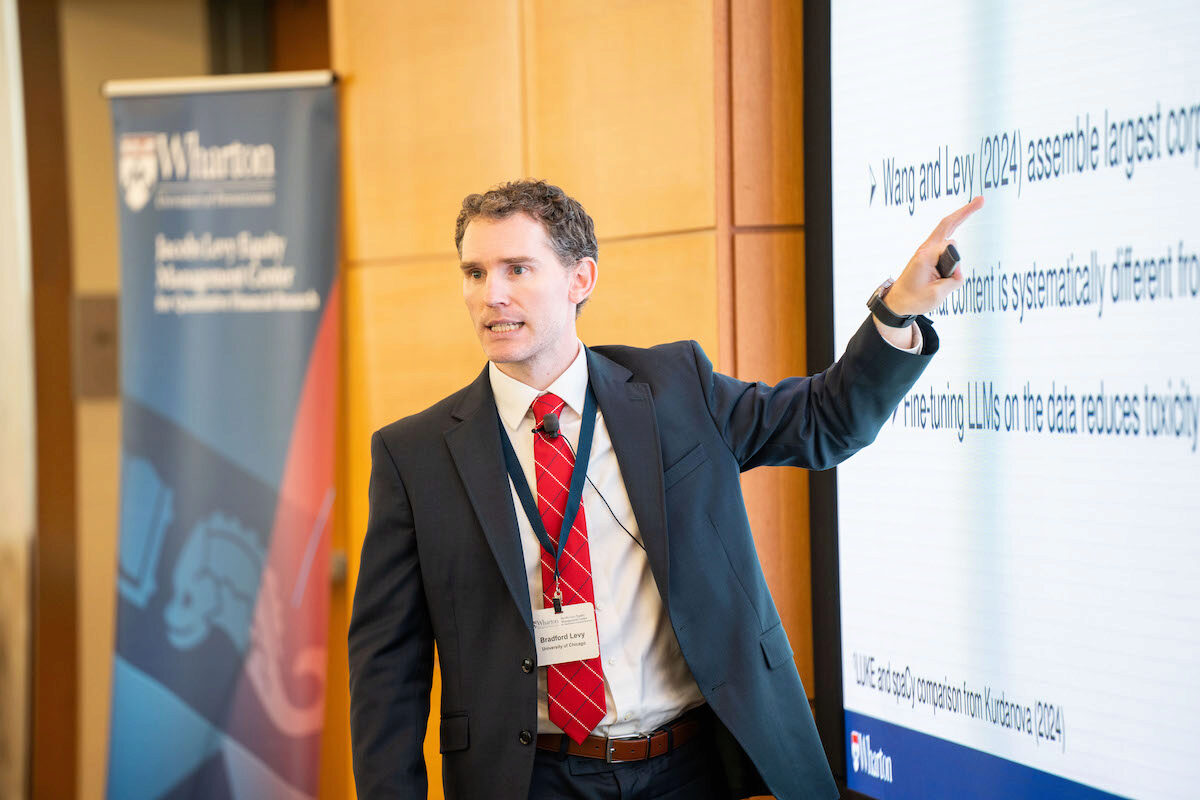 Bradford Levy offers a discussion while pointing to the screen at the Frontiers in Quantitative Finance Conference