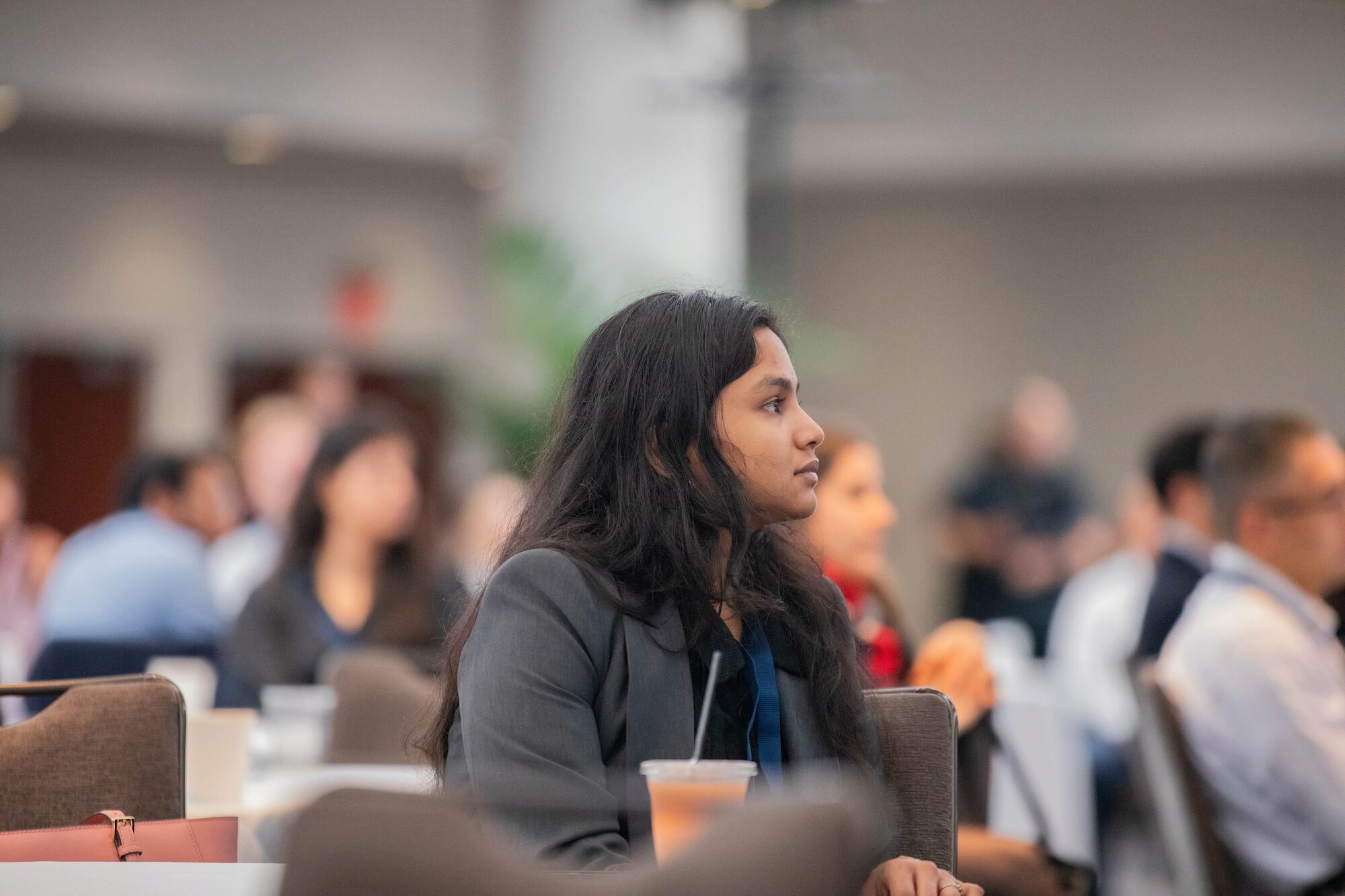 A conference attendee looks to the viewer's right