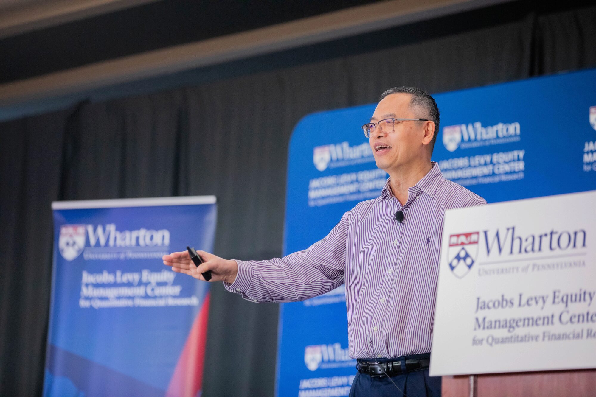 A conference speaker at a podium