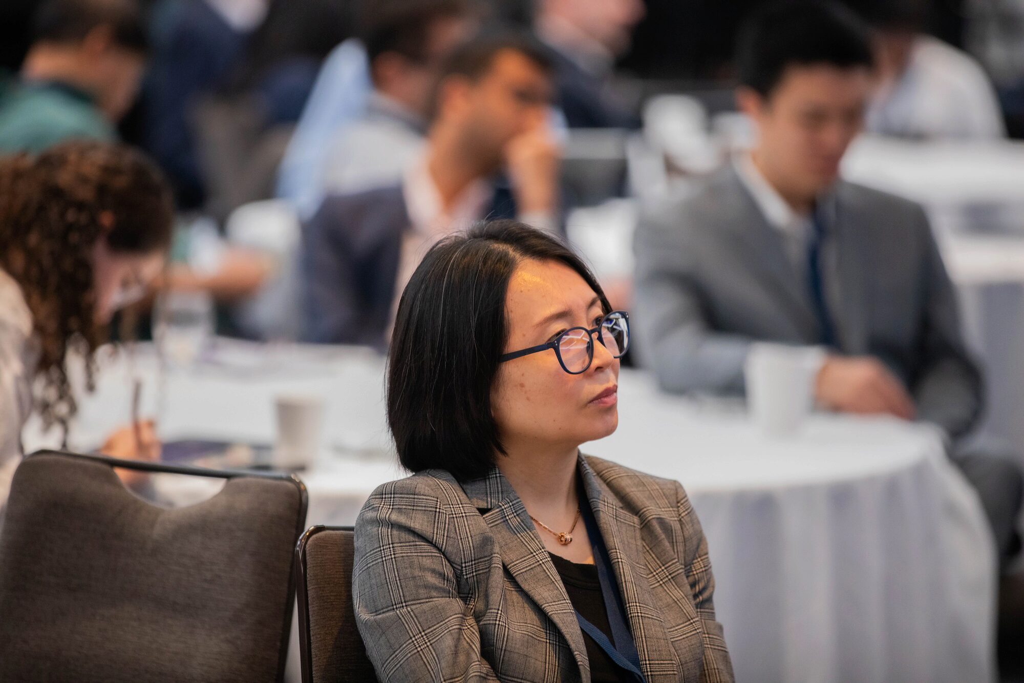 A conference attendee looks to the viewer's right