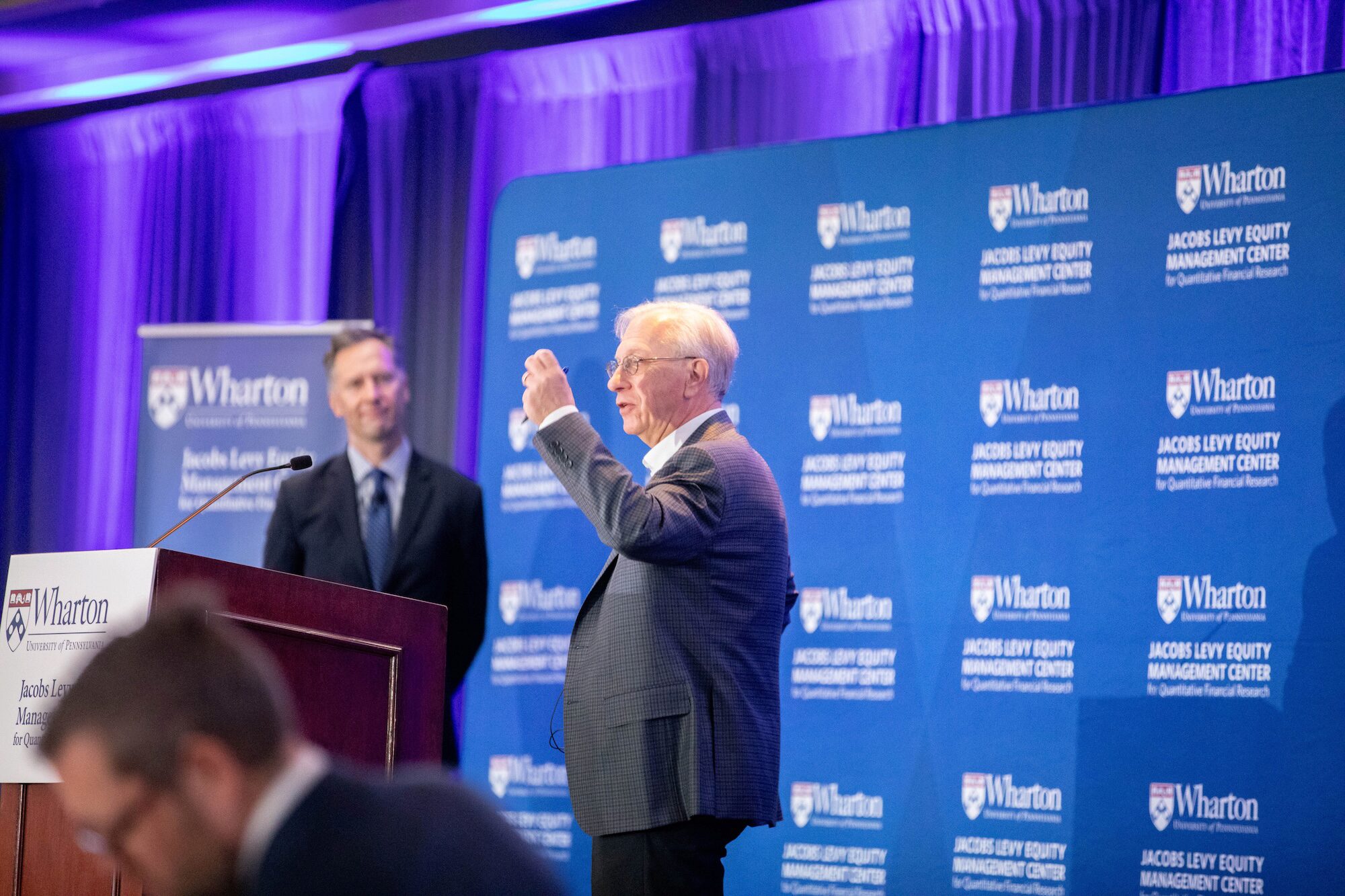 Two conference speakers onstage in conversation