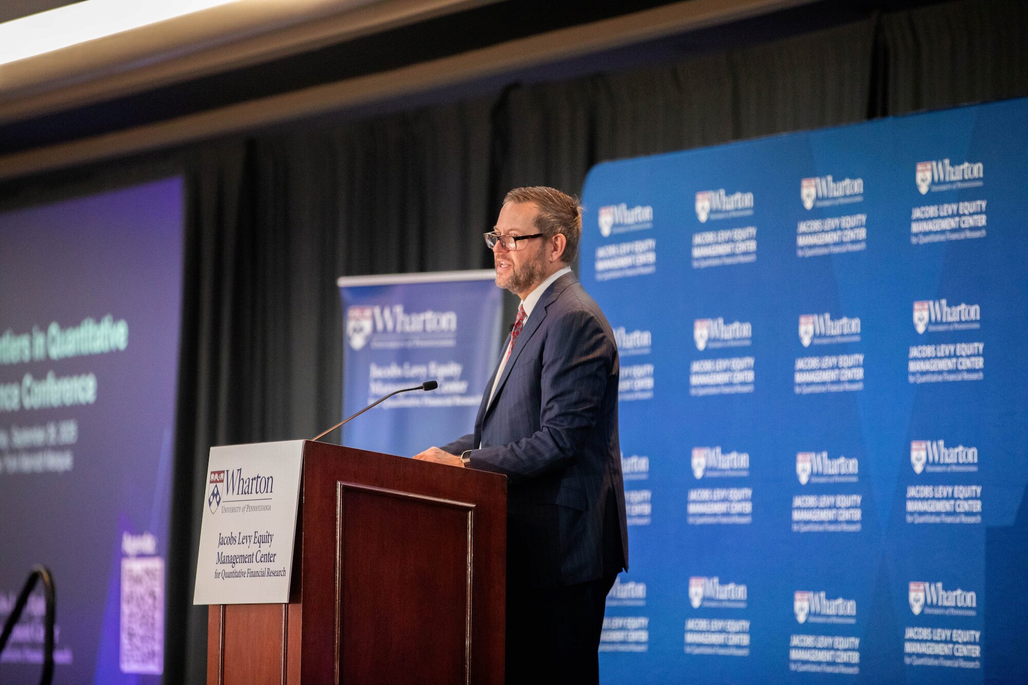 A conference speaker at a podium