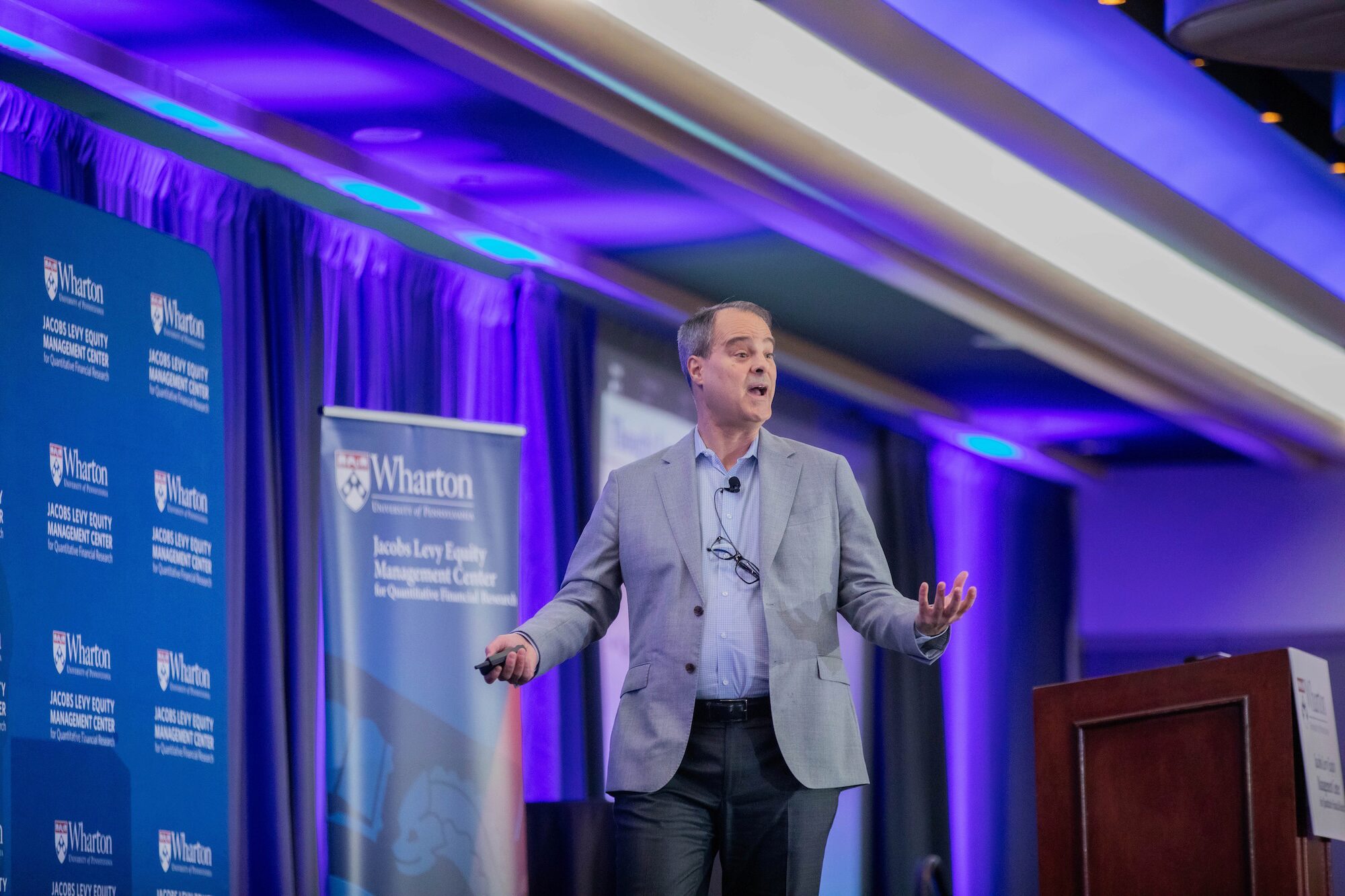 A conference speaker walks while speaking