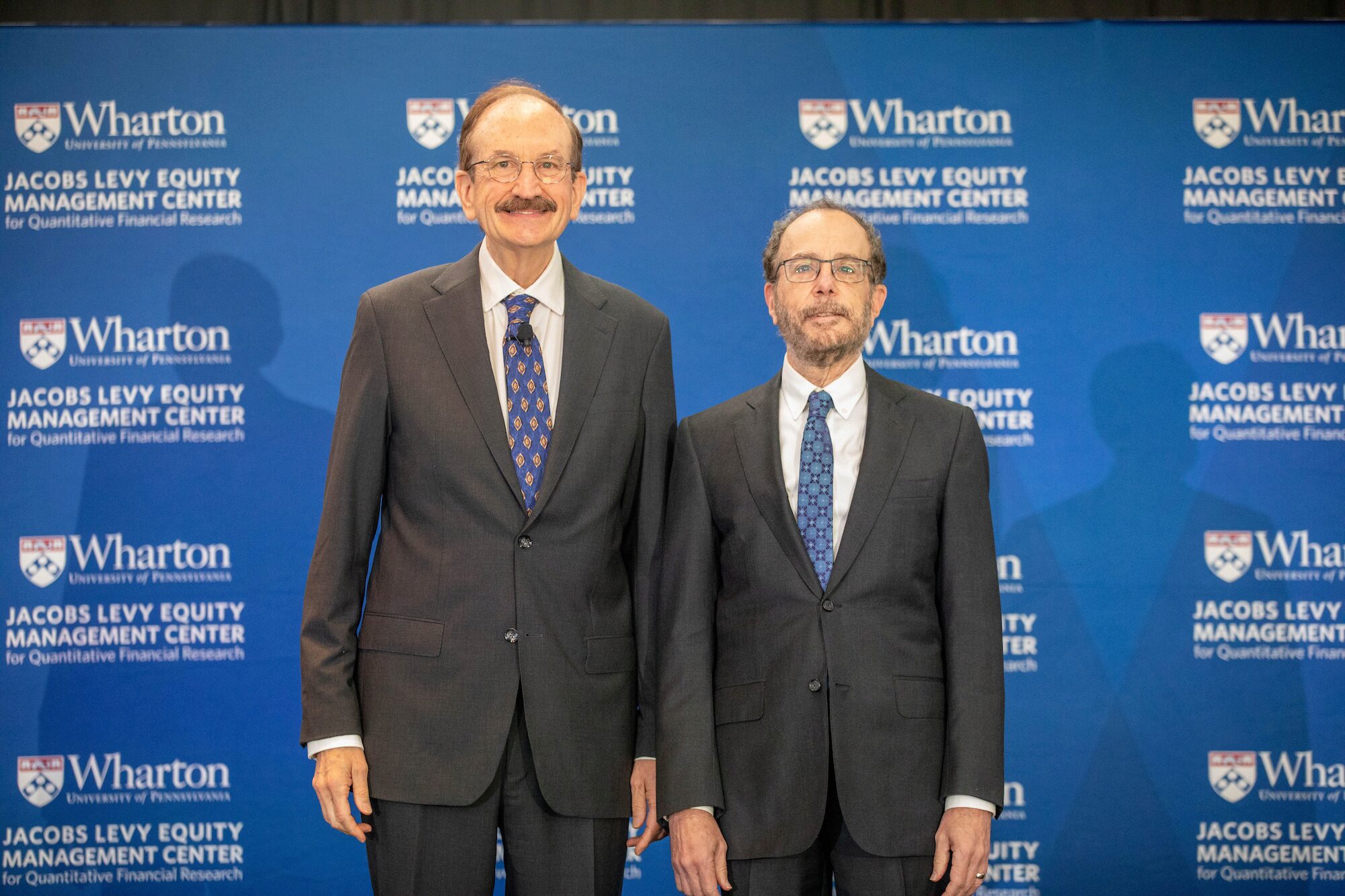 Two people pose for a photo, smiling toward the viewer